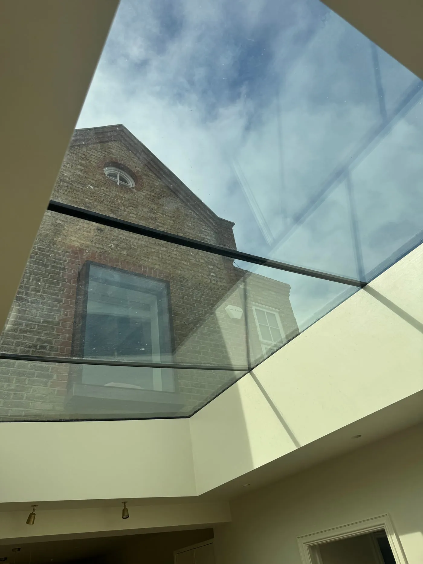 Skylight glazing detail against the original brick gable